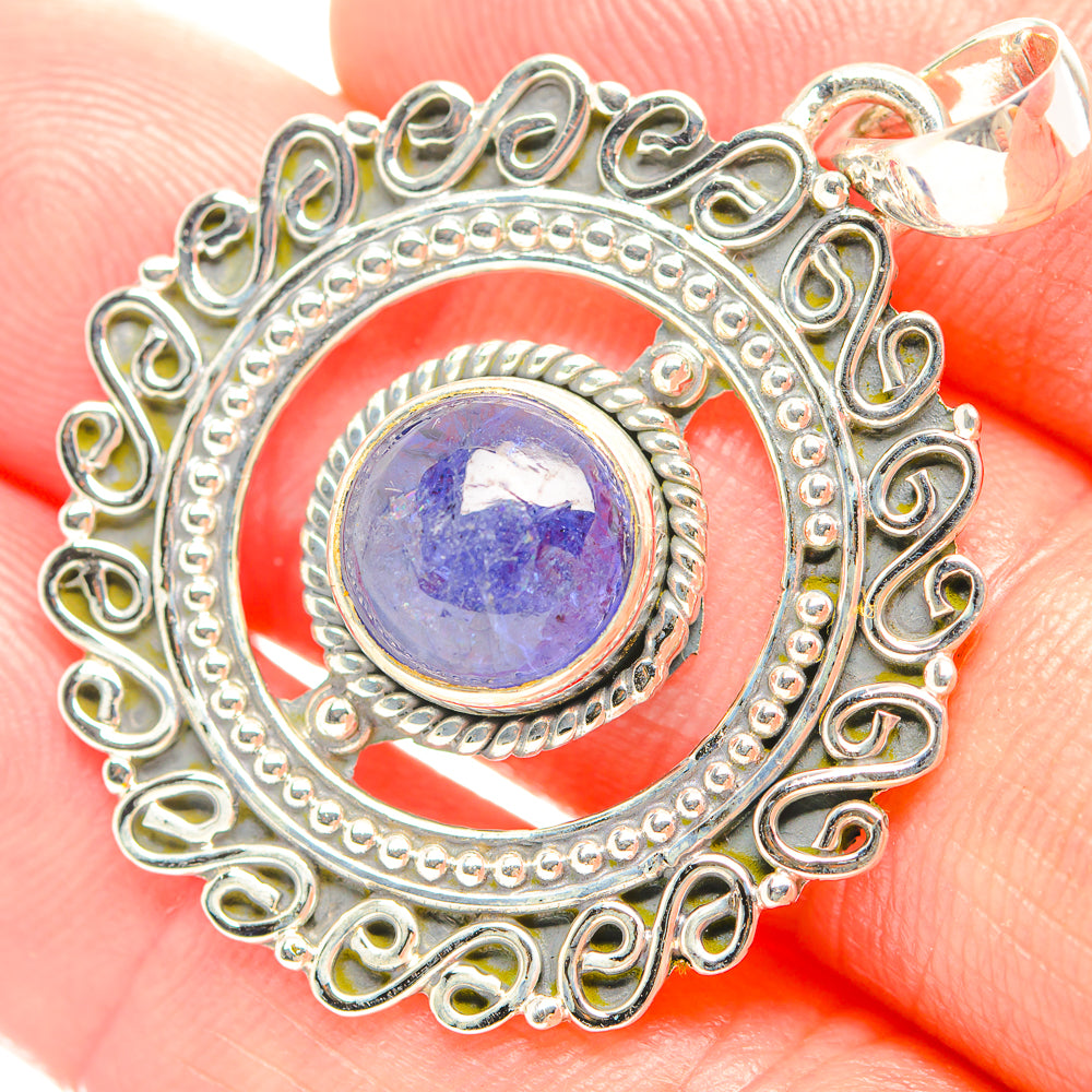Tanzanite pendant with oval blue-purple gemstone in ornate sterling silver bezel