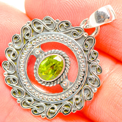 Peridot pendant with round green stone, ornate silver filigree and top bail