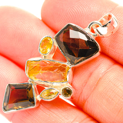 Sterling silver citrine and smoky quartz pendant with faceted stones on finger