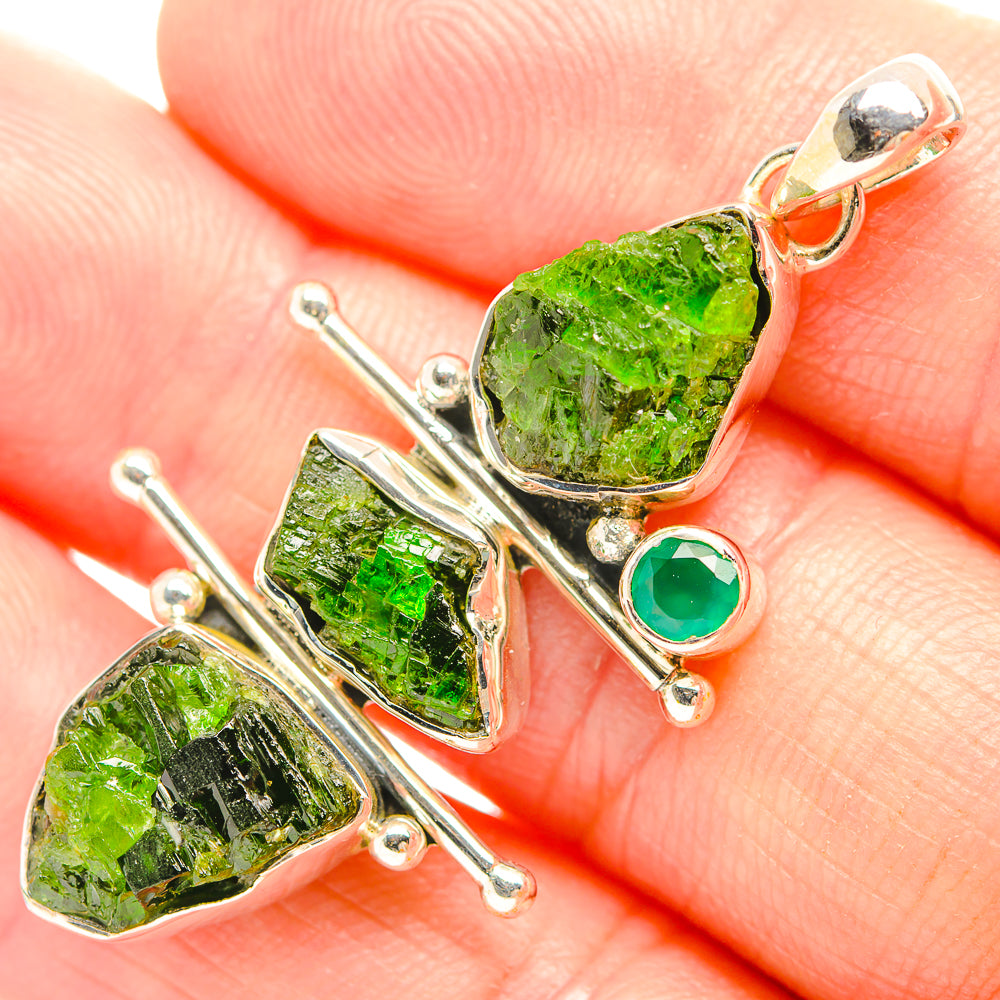 Green rough gemstone pendant closeup: silver leaf frame and small round green bezel