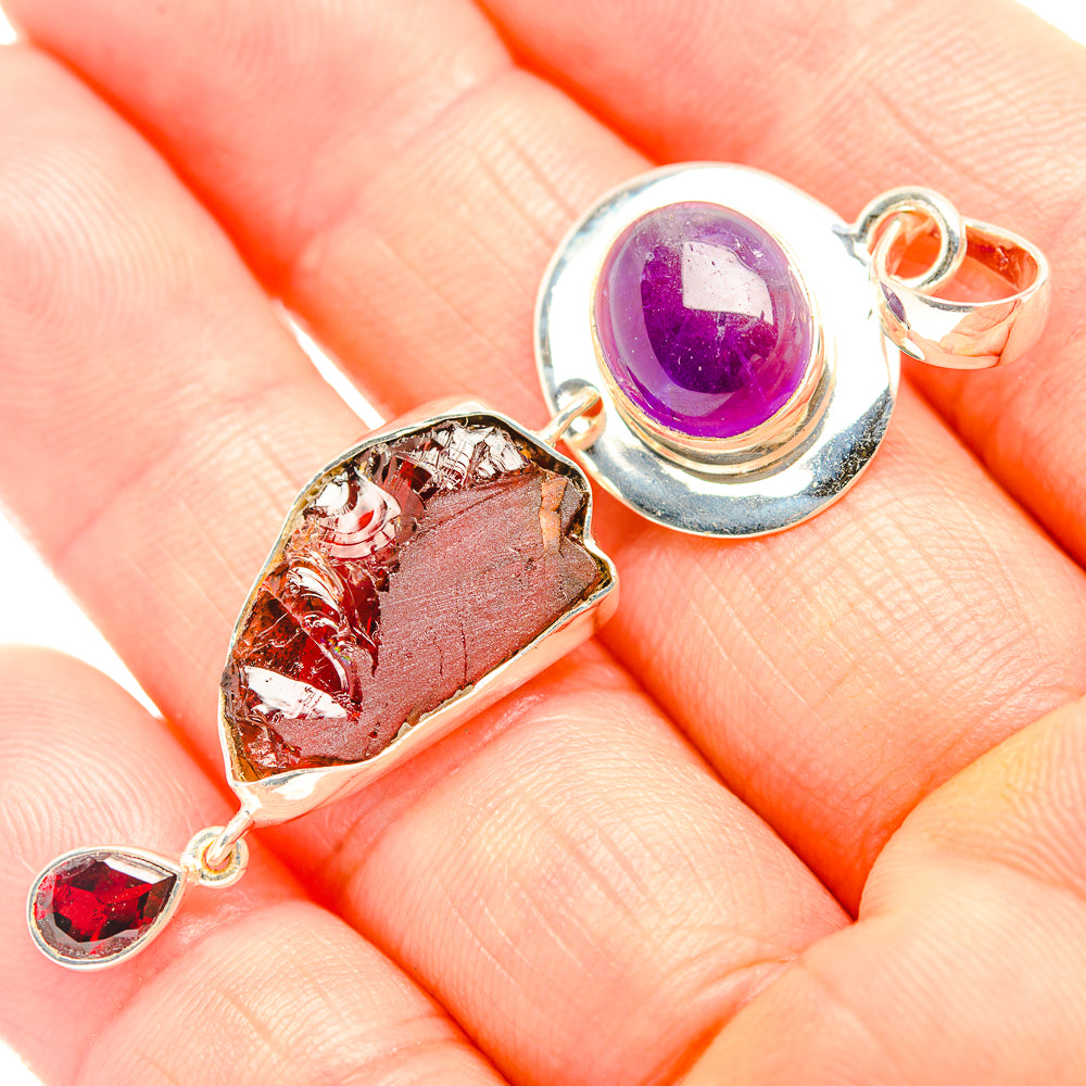 Sterling silver pendant with purple amethyst cabochon and red garnet stones
