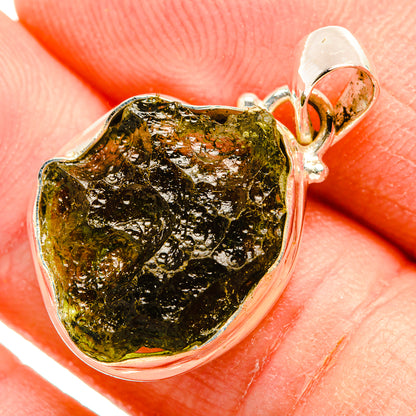 Silver bezel pendant with irregular green-gold Czech Moldavite stone, bail on top