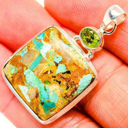 Turquoise and copper mosaic pendant with peridot-green bezel set stone close-up on bail