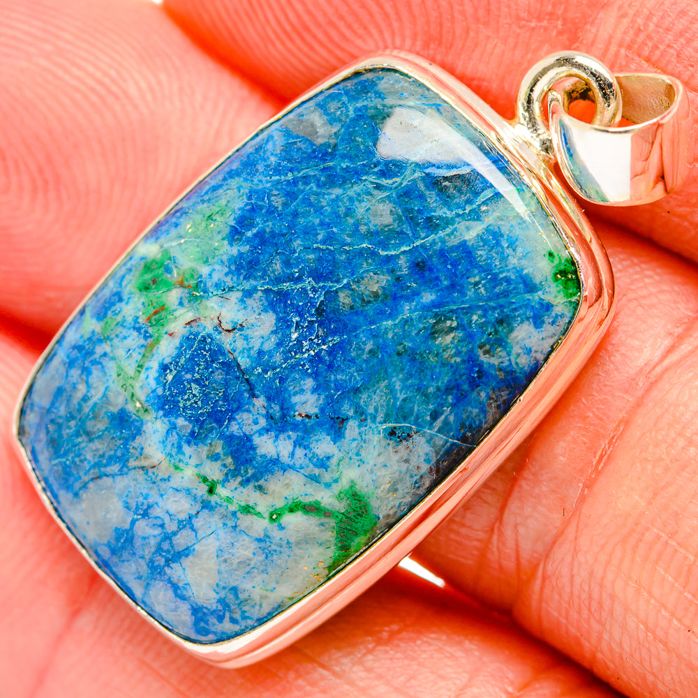 Blue and green apalite stone pendant in silver bezel setting on bale, close-up