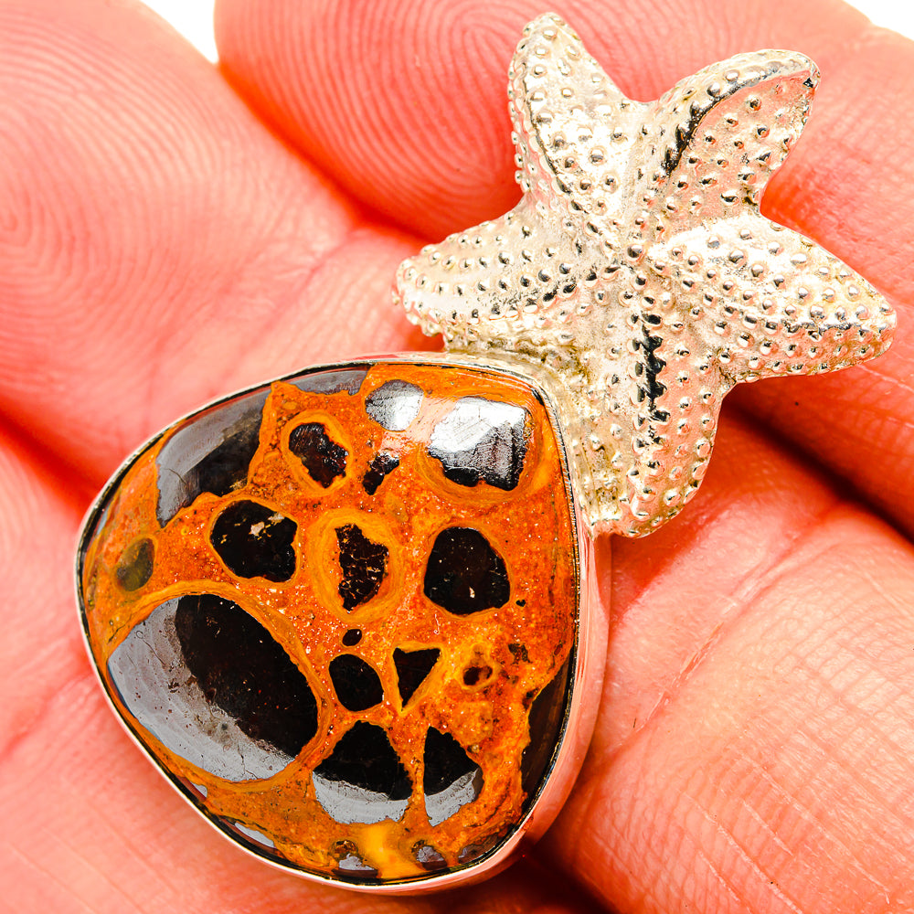 Bauxite pendant with orange, black-spotted stone and textured silver star cap