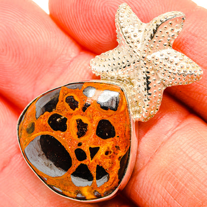 Bauxite pendant with orange, black-spotted stone and textured silver star cap
