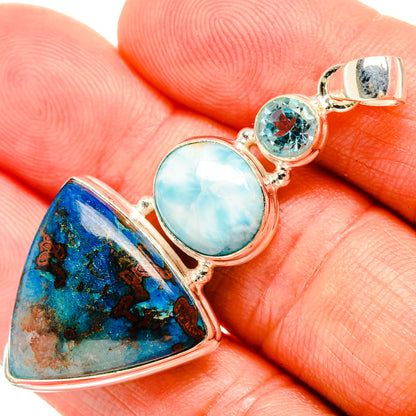 Sterling silver gemstone pendant close-up: blue triangle, oval light-blue stone, round topaz