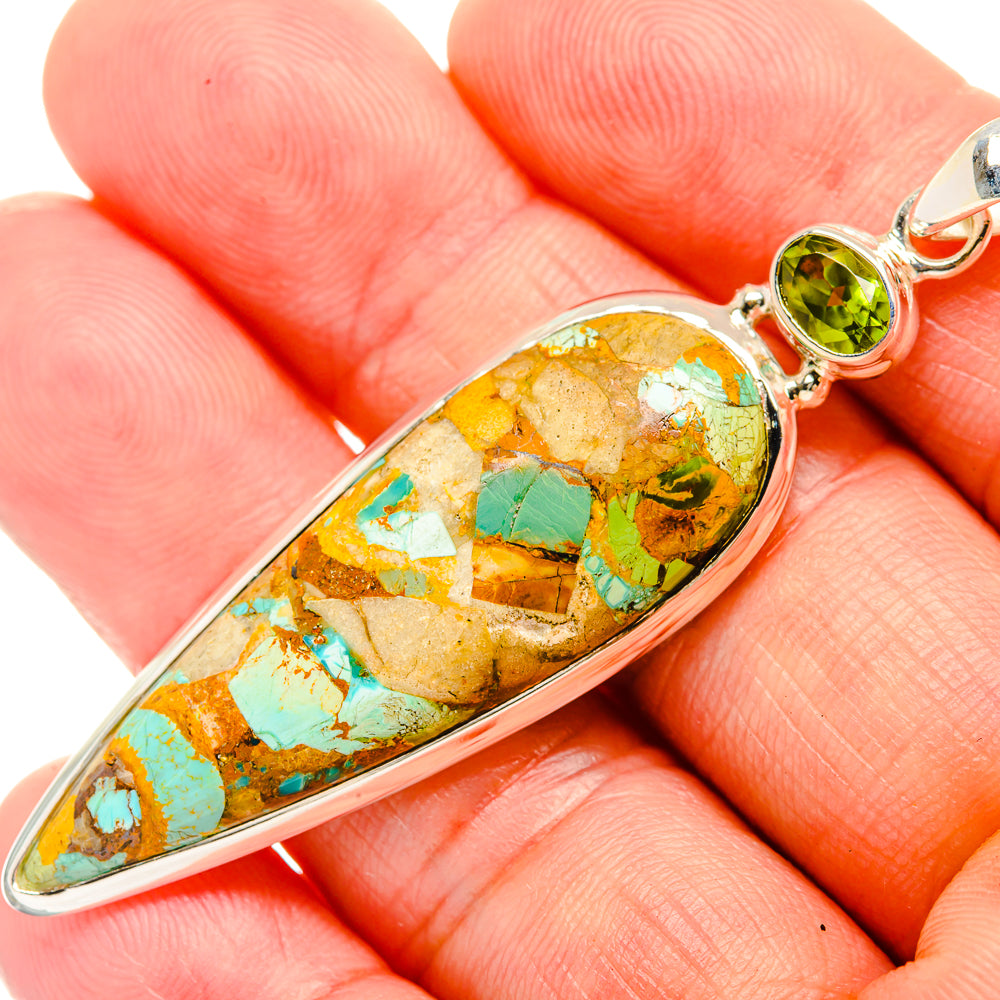 Oval turquoise-mosaic pendant close-up with round green peridot bezel and bail