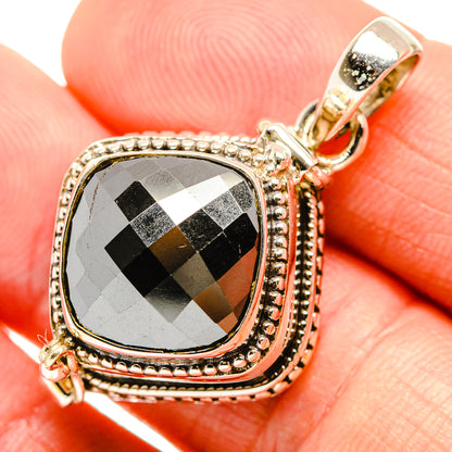 Sterling silver pendant close-up with hematite-look checker pattern and top bail