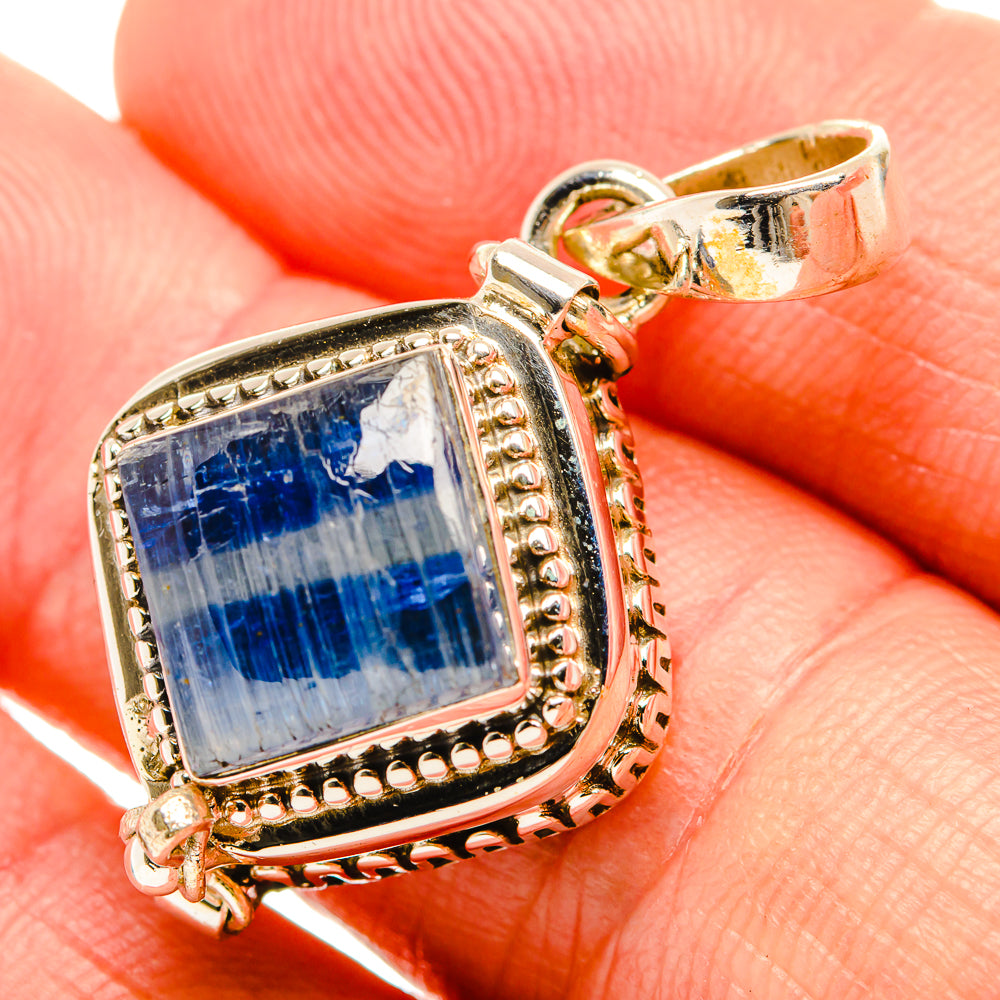 Blue kyanite pendant closeup in square sterling silver bezel with bail and accents