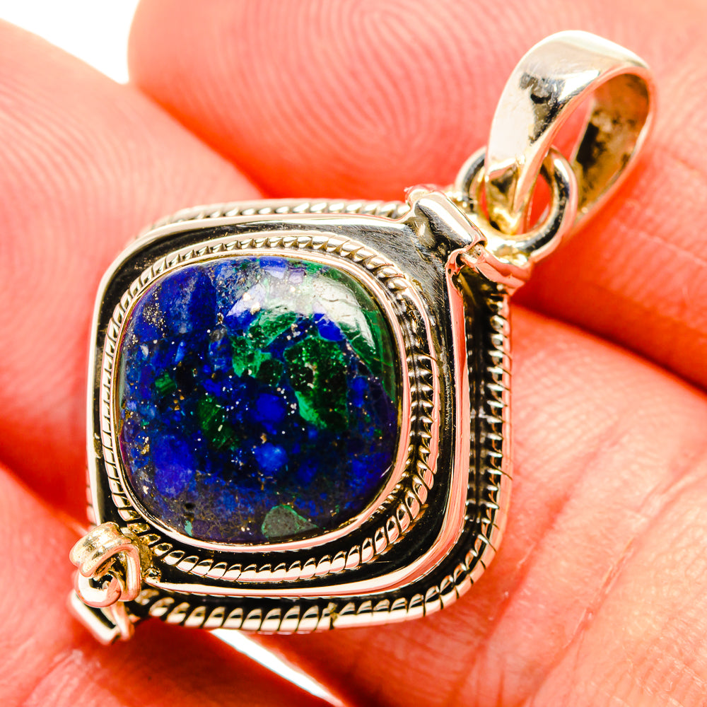 Sterling silver lapis lazuli pendant with oval blue stone in ornate bezel