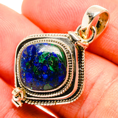Sterling silver lapis lazuli pendant with oval blue stone in ornate bezel