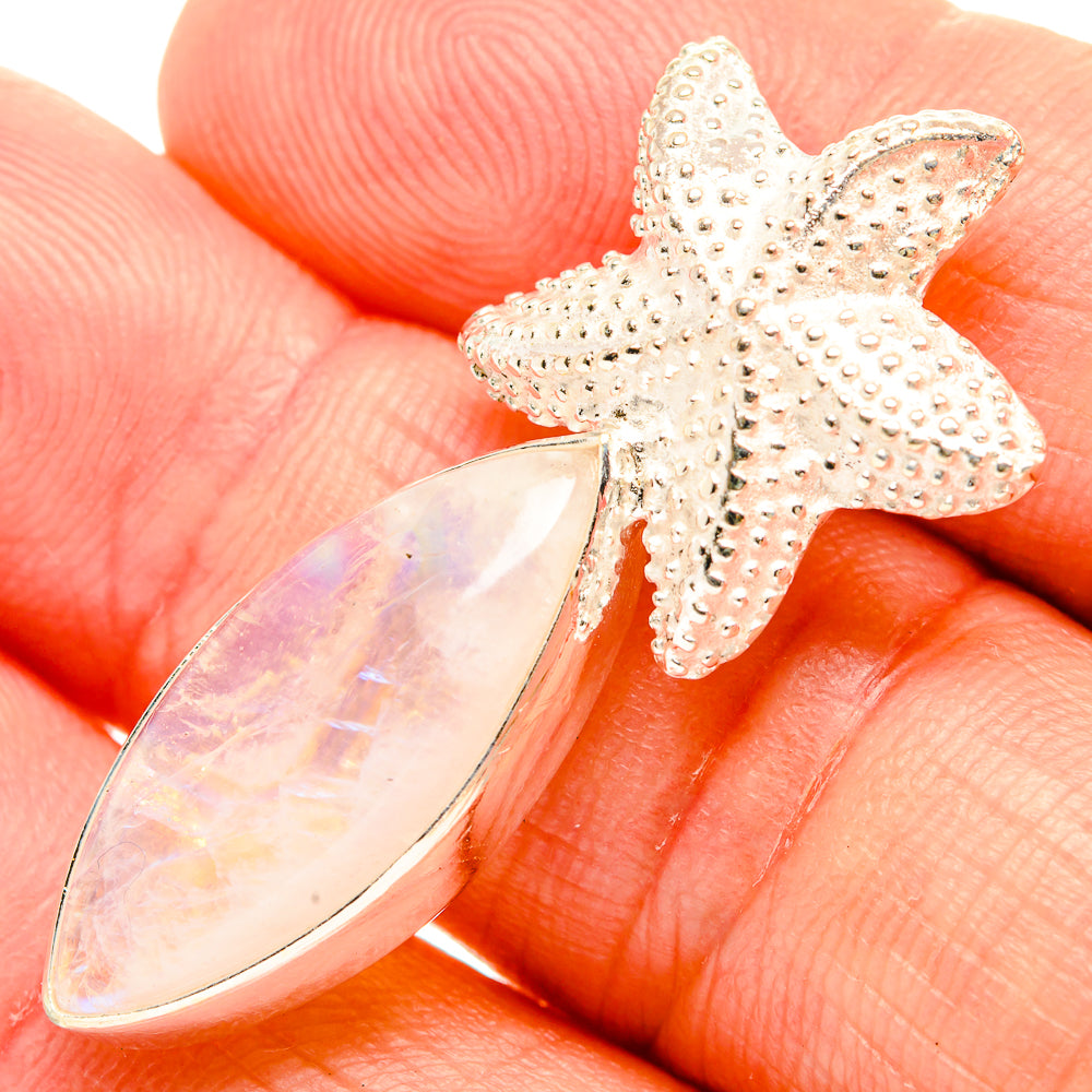 Starfish pendant with textured silver tone and opal-like teardrop stone
