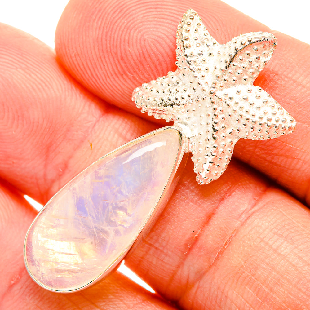 Sterling silver starfish pendant with iridescent opal teardrop cabochon close-up