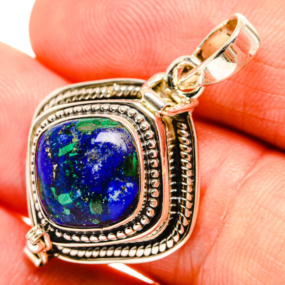 Sterling silver lapis lazuli pendant with ornate bezel and round blue gemstone, green flecks
