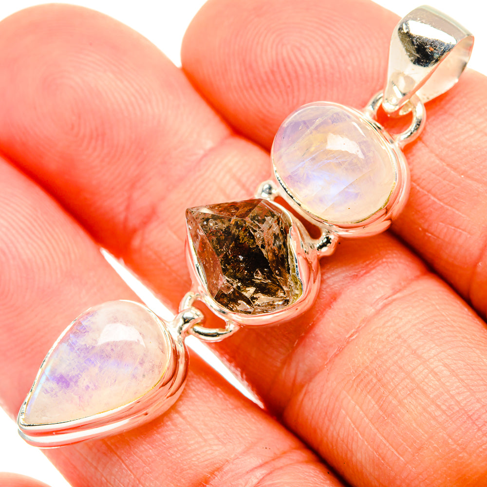 Close-up 925 silver pendant with moonstone opal teardrops and rough brown crystal