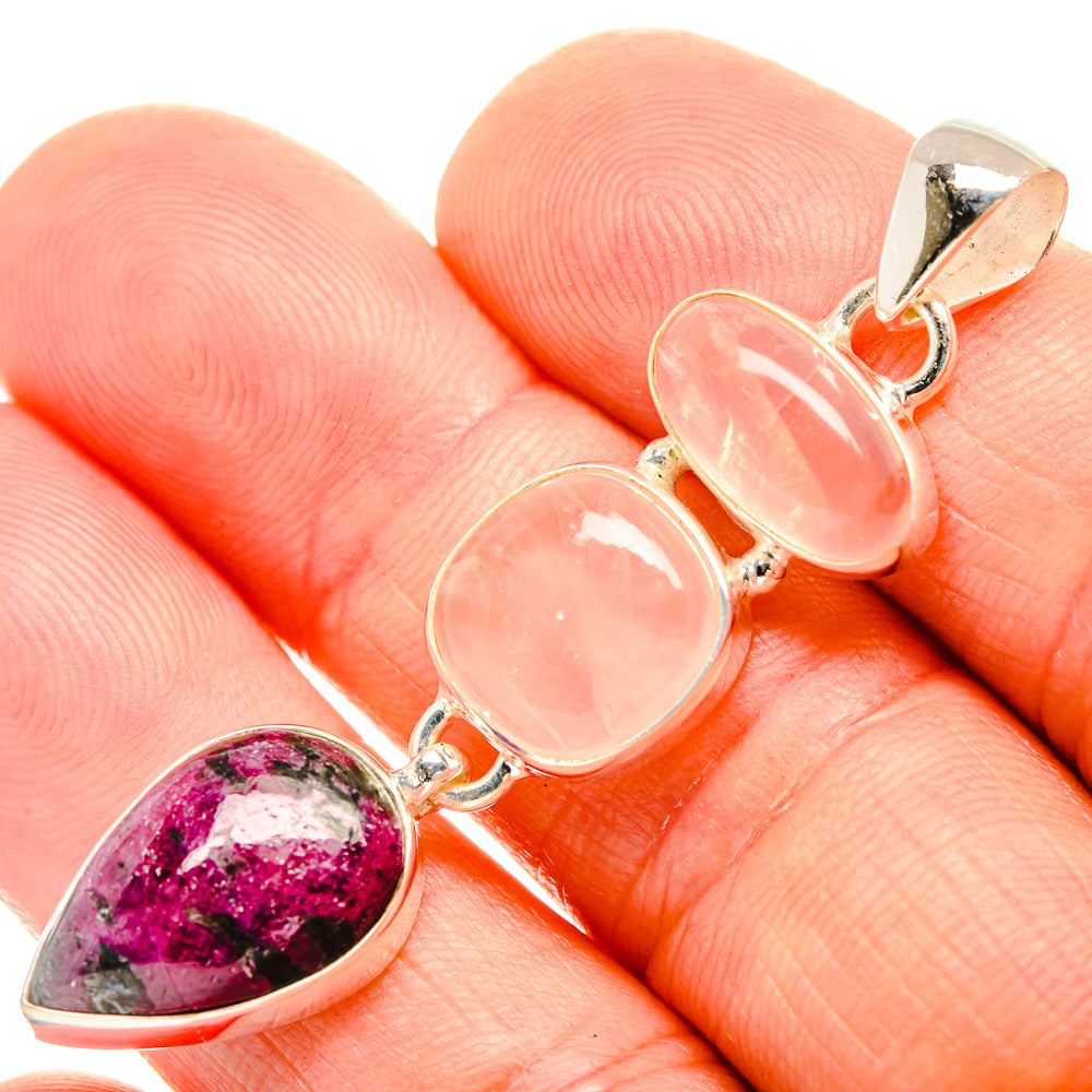 Gemstone pendant with magenta teardrop and two pink oval cabochons in silver setting