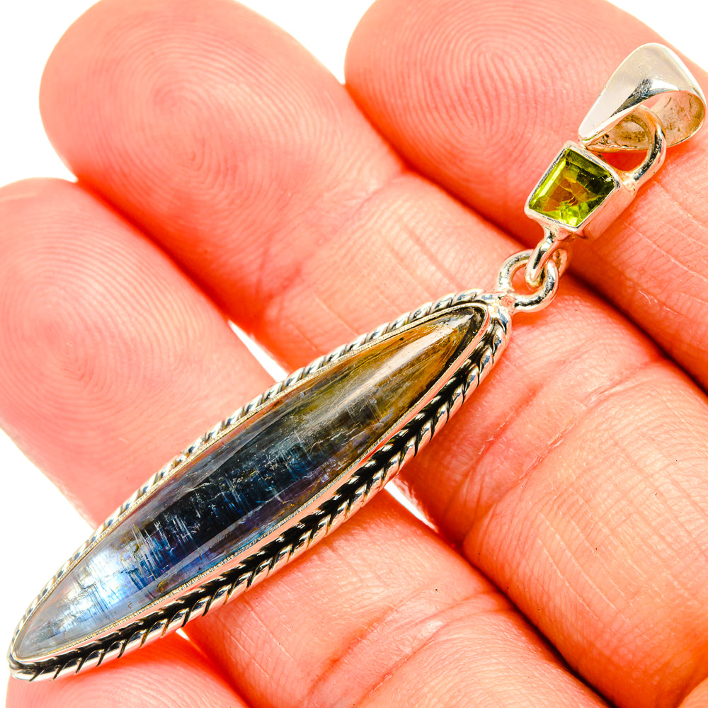 Close-up leaf kyanite pendant with green peridot square, silver-tone prong setting