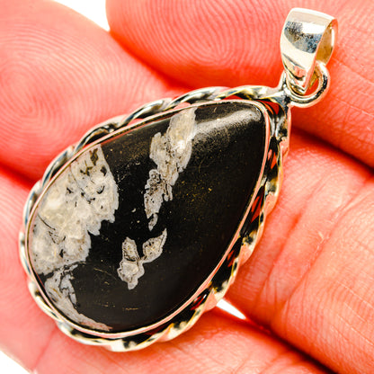 Chrysanthemum stone pendant in silver bezel, black teardrop with white pattern and bail