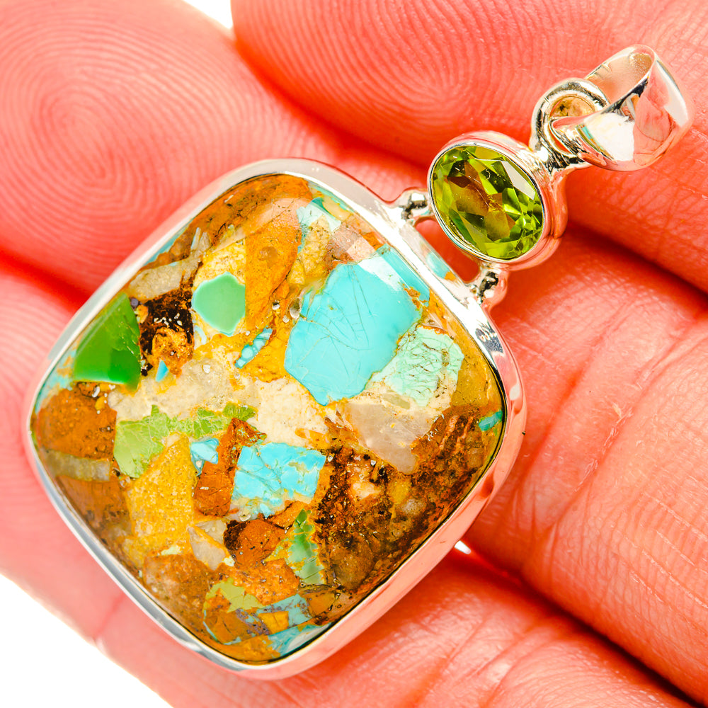 Close view sterling silver pendant with turquoise mosaic teardrop stone and green peridot bail