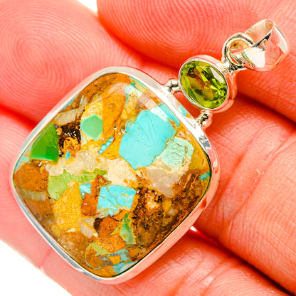 Close view sterling silver pendant with turquoise mosaic teardrop stone and green peridot bail