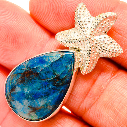 Apatite pendant with teardrop blue cabochon and textured starfish silver charm