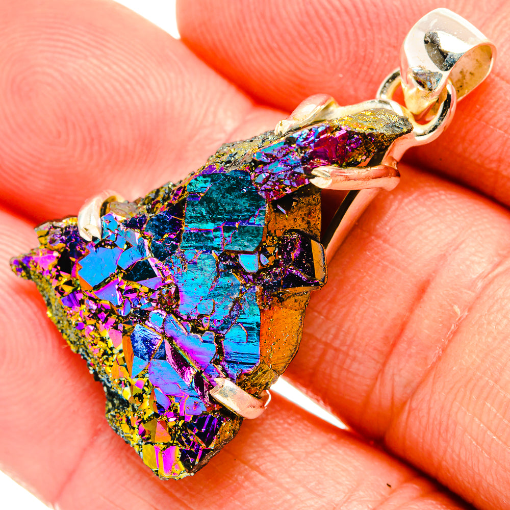 Close-up of rainbow druzy pendant on silver bail, faceted iridescent crystal