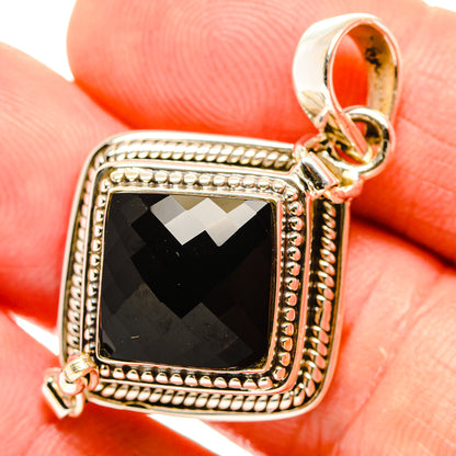 Black onyx pendant with square faceted stone, sterling silver frame and bail