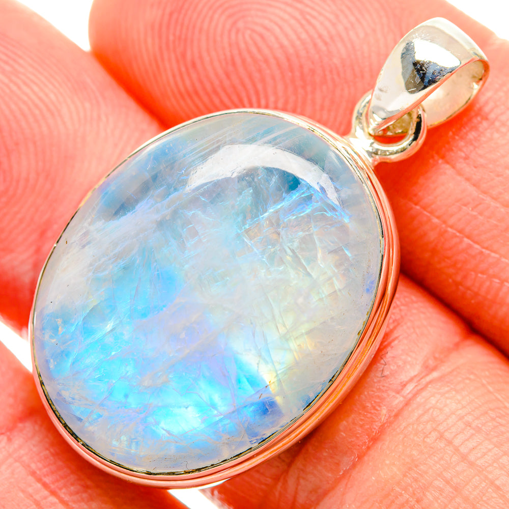 Oval rainbow moonstone pendant in sterling silver bezel, blue opal glow