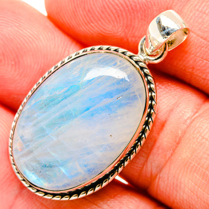 Rainbow moonstone pendant with oval blue opalescent stone and engraved metal bezel