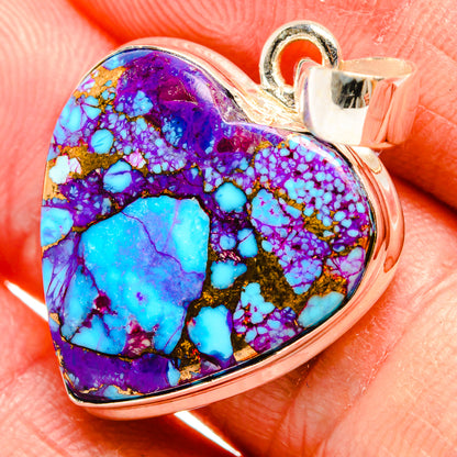 Heart-shaped turquoise pendant close-up with purple-blue mosaic stone in silver bezel