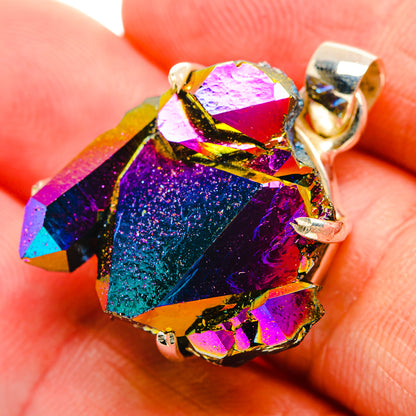 Oval rainbow druzy pendant with gold-tone top loop and facet bezel, close-up on stone