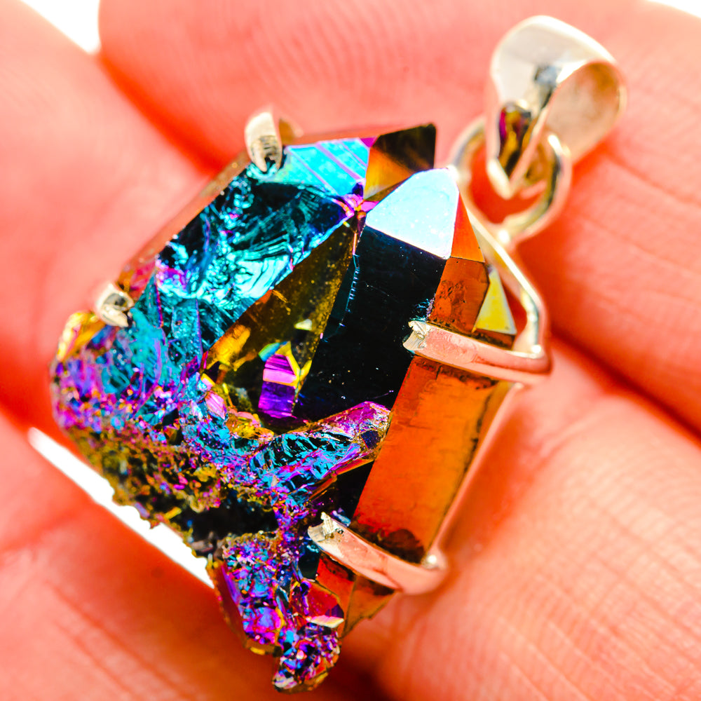 Close-up iridescent druzy pendant with silver bail and prongs, blue purple gold tones