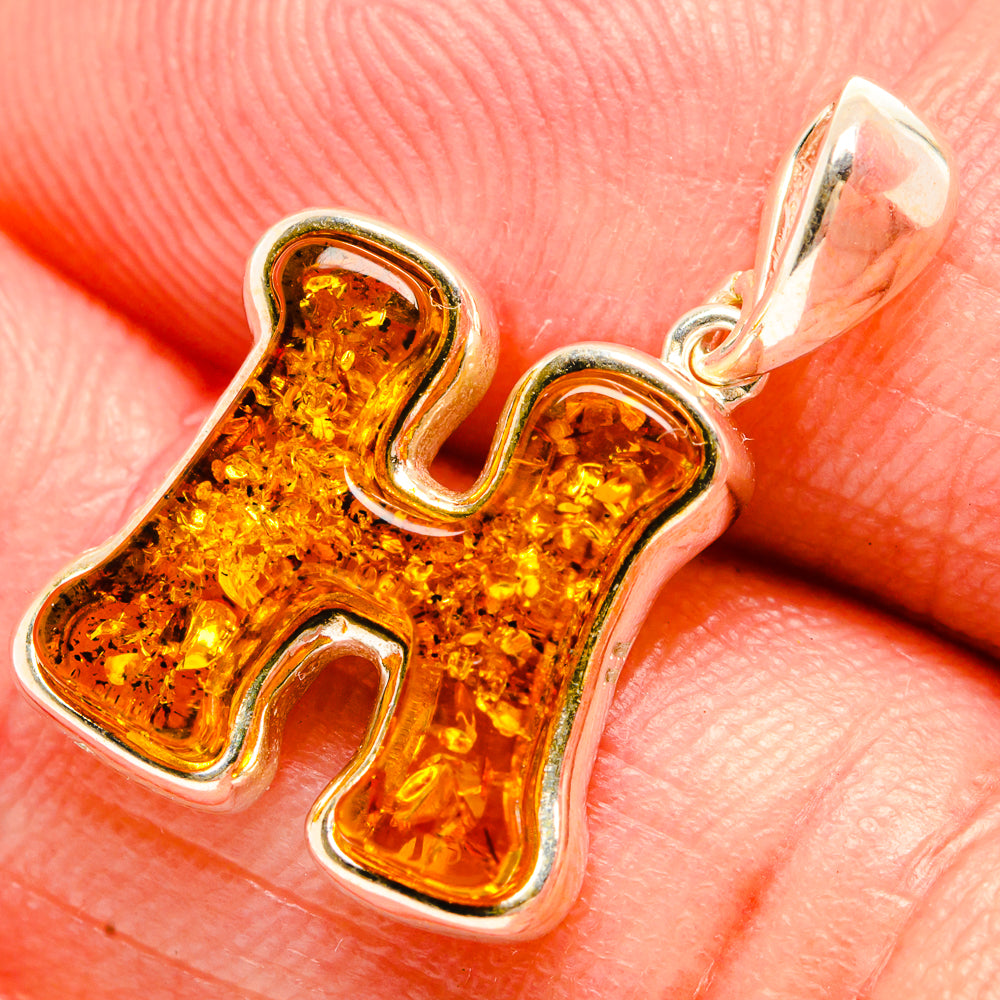 Amber letter H pendant in 925 sterling silver with a carved frame, yellow-orange amber.