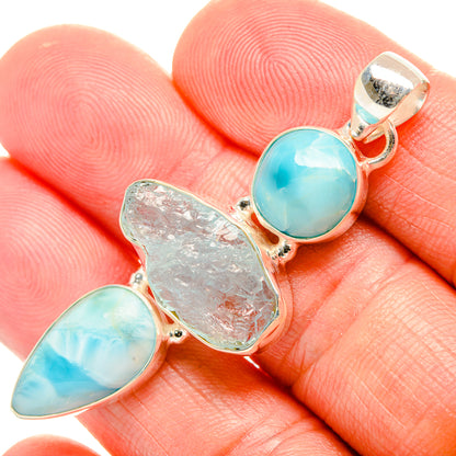 Larimar pendant close-up, 925 sterling silver with round blue cabochon and rough centerpiece