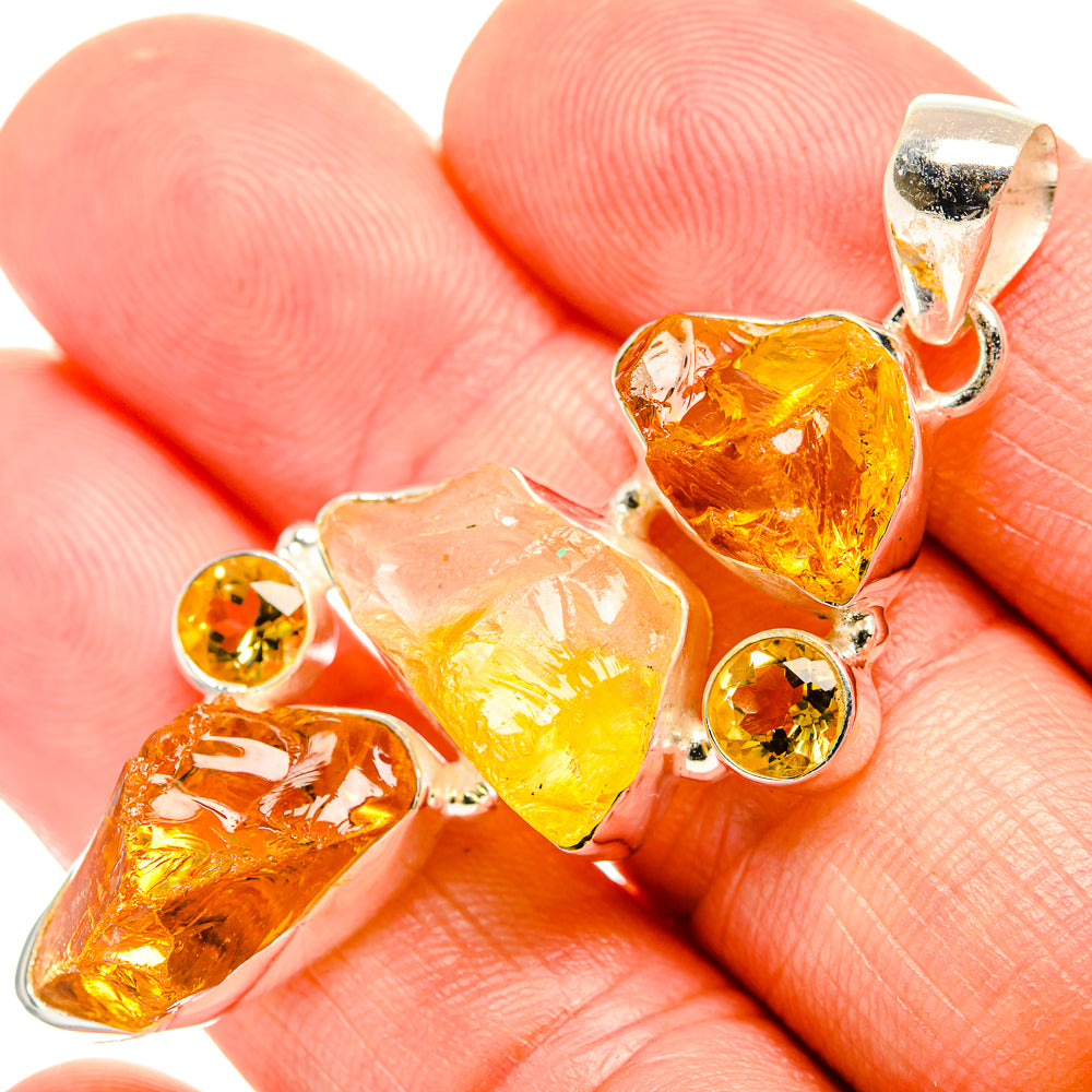 Rough citrine and carnelian pendant close-up with sterling silver prongs and round yellow accents