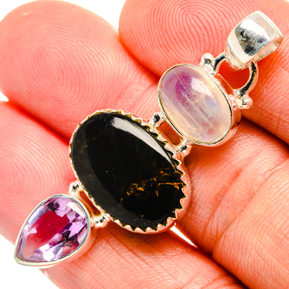 Sterling silver pendant with black oval stone, oval opal-like stone, and purple teardrop