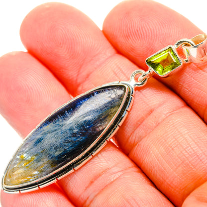 Sterling silver kyanite teardrop pendant with green peridot accent, on bail