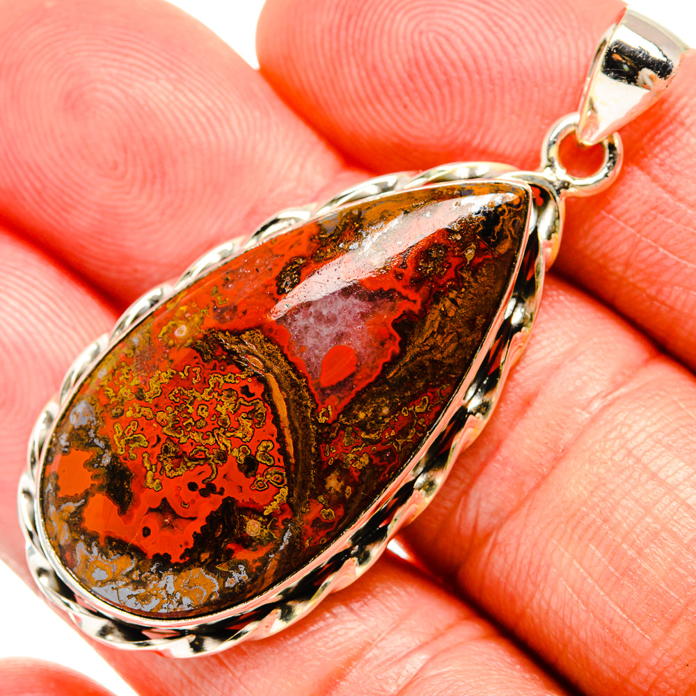 Sterling silver teardrop agate pendant close-up with red-orange patterned stone and bail