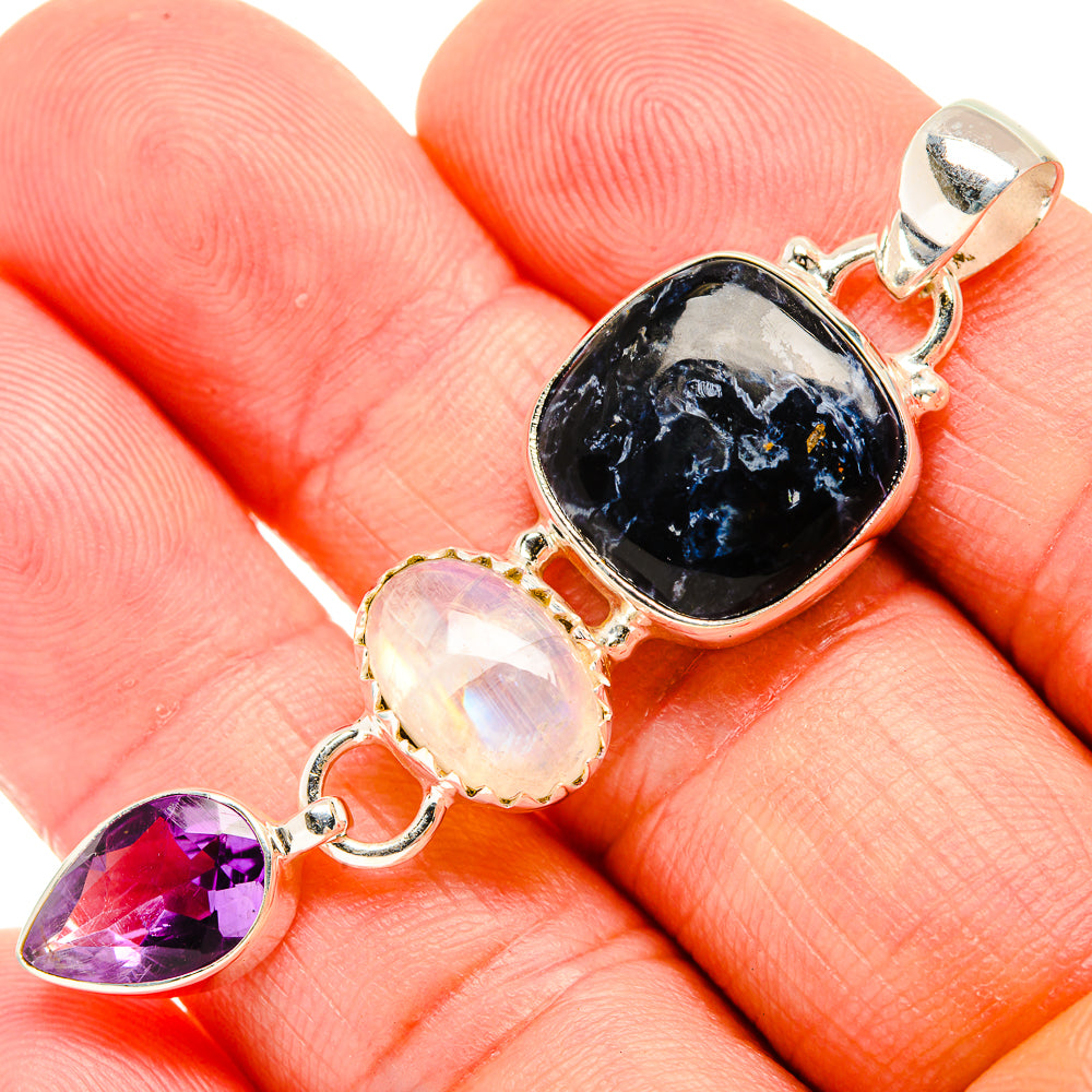 Sterling silver gemstone pendant with dark oval, opalescent oval, and purple teardrop stones