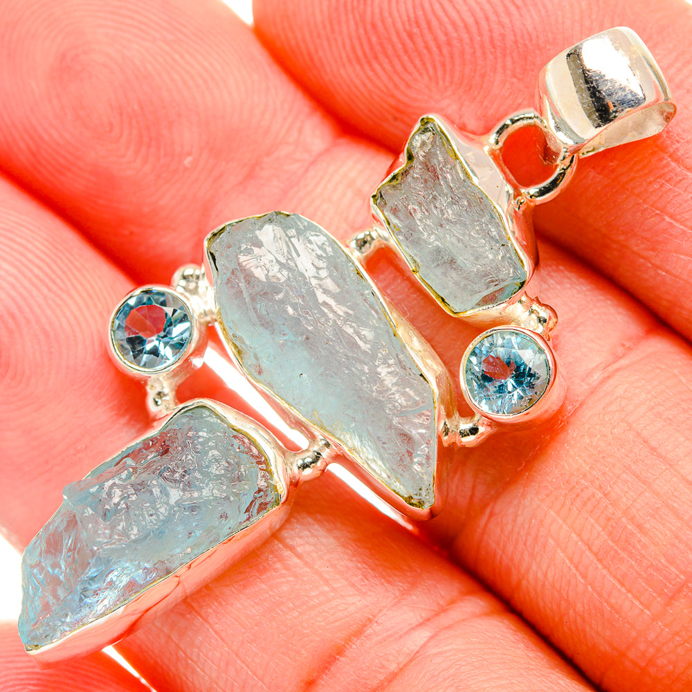 Rough aquamarine and blue topaz sterling silver pendant, close-up on stone settings
