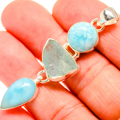 Sterling silver pendant featuring round blue larimar with rough green center and teardrop blue ends