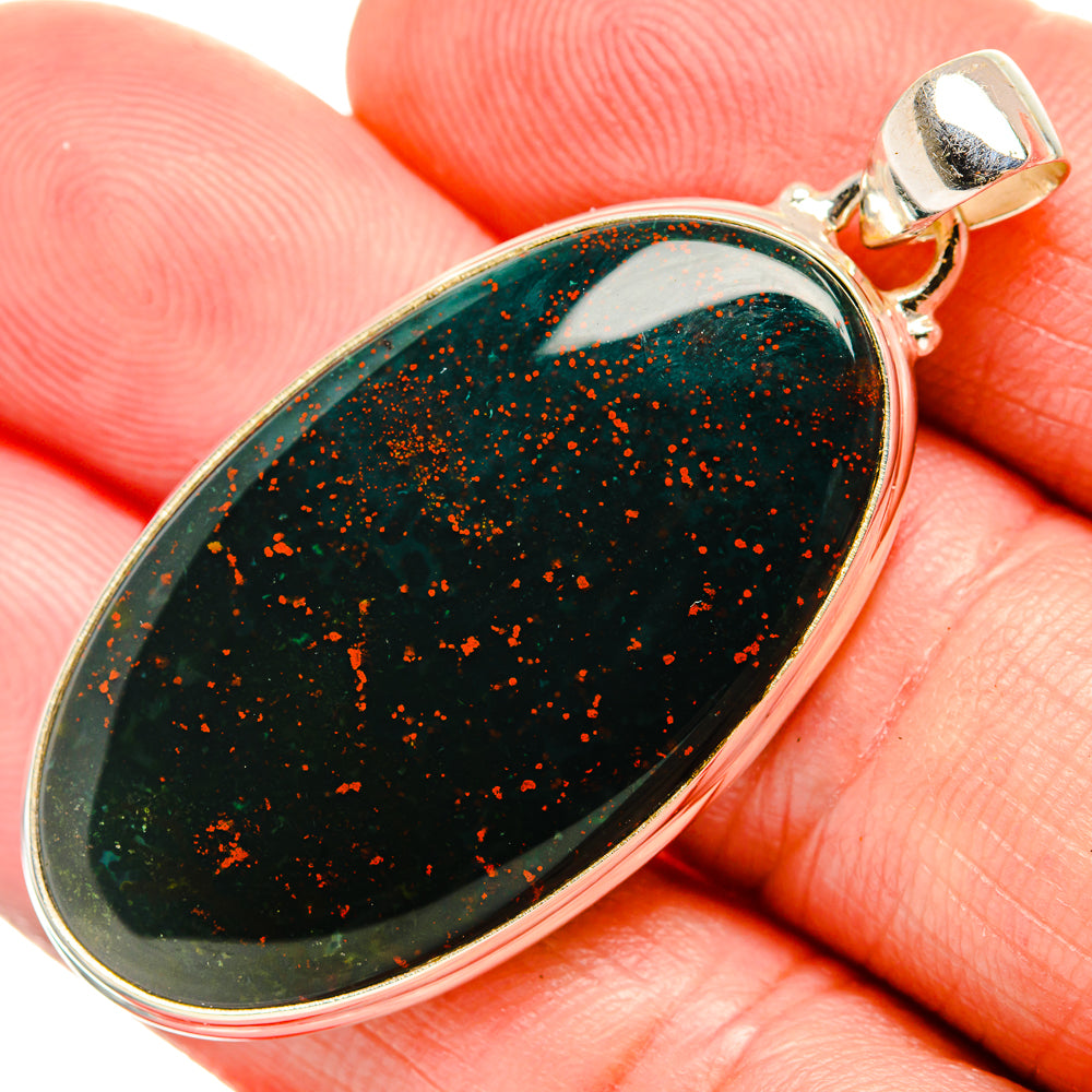 Bloodstone pendant close-up on 925 sterling silver bail; dark green with orange flecks