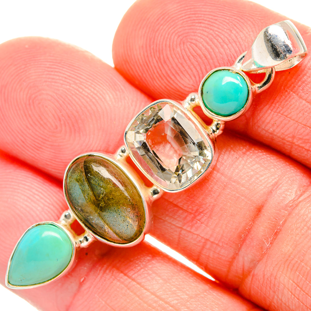 Gemstone pendant with green teardrop cabochons and clear center stone in silver setting