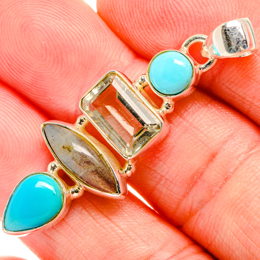 Sterling silver pendant with blue round and marquise stones, plus faceted yellow-green center