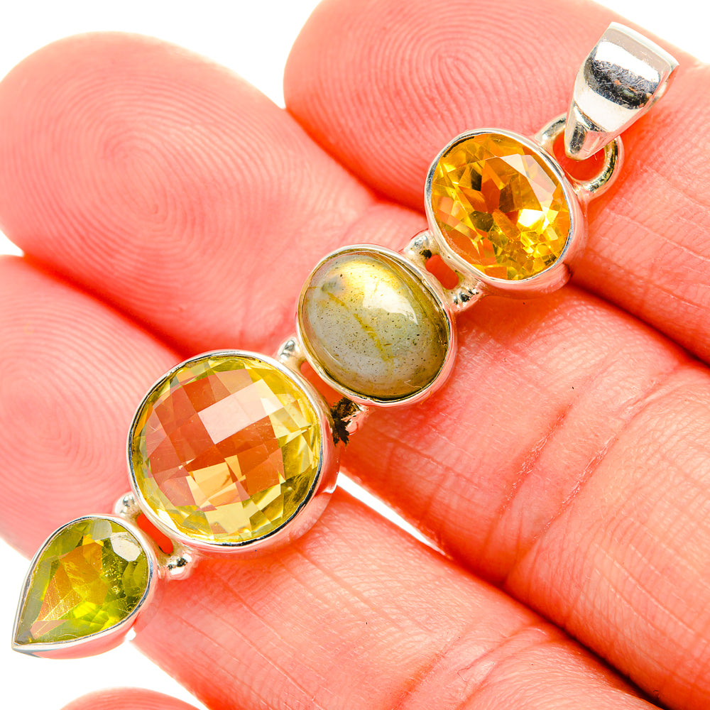 Sterling silver pendant with faceted yellow and green gemstones, including round labradorite