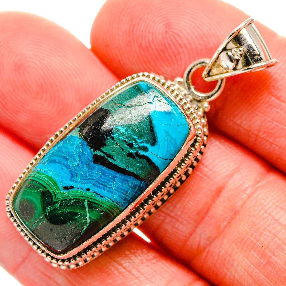 Oval teal-green gemstone pendant with textured silver frame and top loop bail