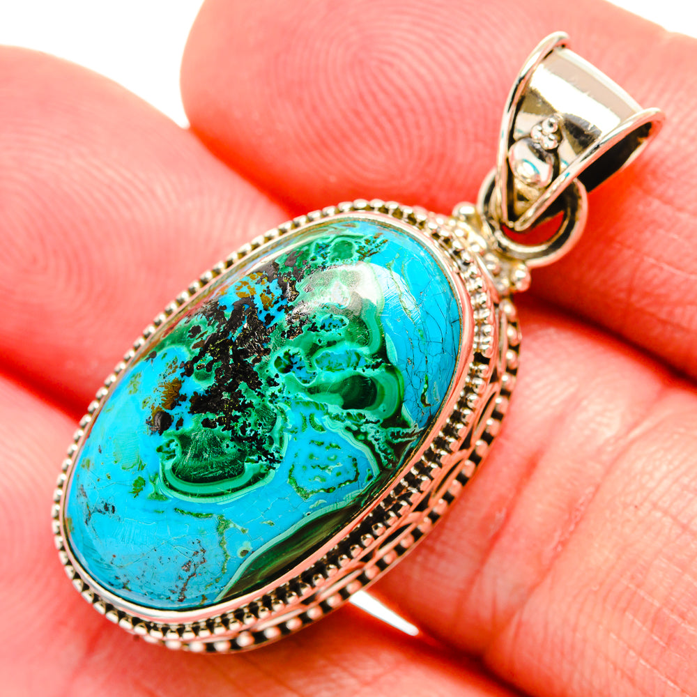 Sterling silver oval pendant with blue-green stone and teardrop bail on top