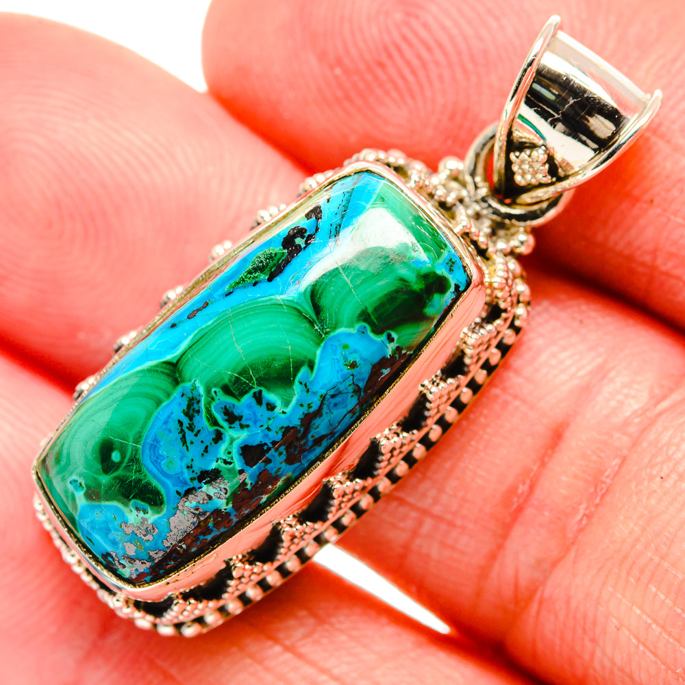 Oval chrysocolla-malachite pendant in green and blue with silver bezel, bail top.