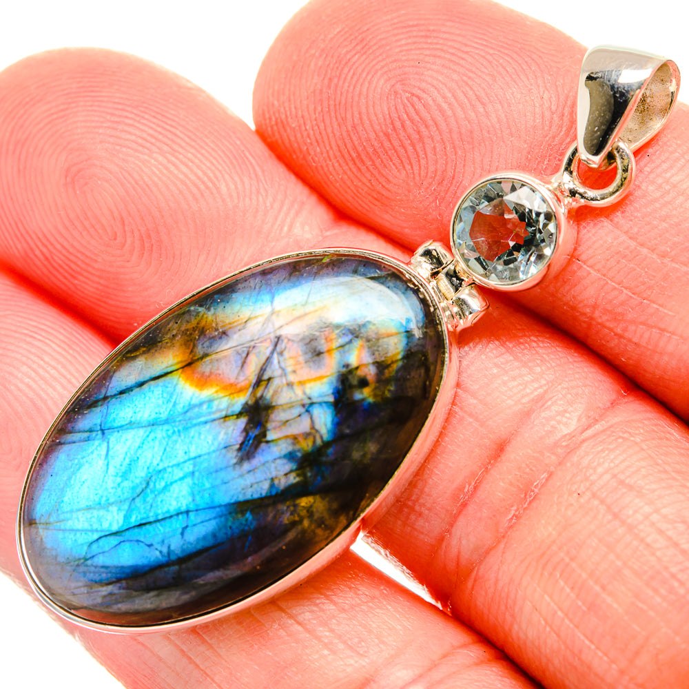 Oval labradorite pendant with blue flash, round blue topaz accents, 925 silver setting